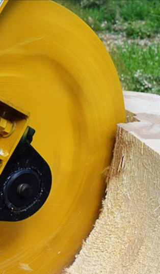 Close-up of a grinder being used on a tree stump